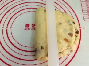 把擀平部分折叠到上方，用擀面杖压下。