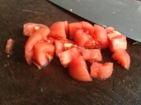 用刀在番茄表皮划十字，再煮一下，轻易去皮，切小块