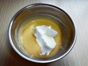 用硅胶刀取三分之的蛋白放入蛋黄糊容易中，翻拌均匀(切记手法，不要划算搅拌，以免消泡) 从底下往上翻拌，手法要轻轻的。 再取三分之一的蛋白霜加入蛋黄糊中，继续上面的手法，翻拌直至看不到蛋白霜。