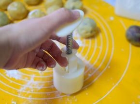 再把上一步包好的月饼生胚放在模具中