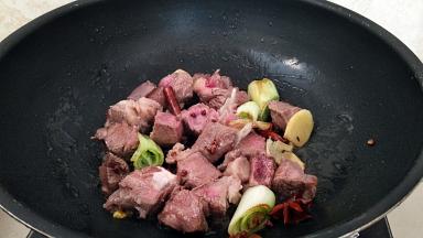 放入牛肉煸炒几下，炒掉多余的水分。