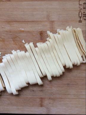 将豆腐皮切条状。