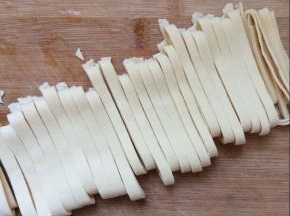 将豆腐皮切条状。