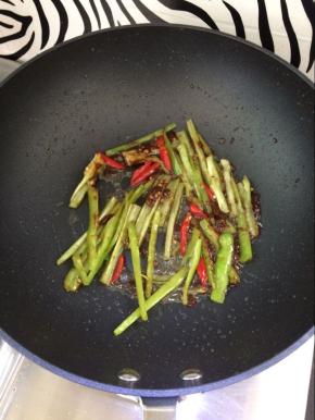 炒香后加入青椒和小米椒，翻炒均匀。