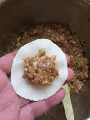 包入调好的馅。