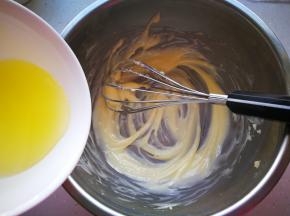 软化的黄油加入玉米油，搅拌至顺滑的状态，加入蛋清再次搅拌均匀。