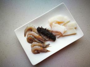 鱿鱼打十字花刀，即食海参提前拿出来解冻，鹰爪虾洗净后去虾线。