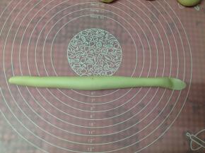 用两手掌心慢慢将其搓长，长度约22—24厘米。搓的时候将左手边的一端稍微搓细一点，右手端用手掌压扁后将其擀薄