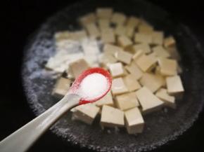 锅里提前烧水，放入一勺盐，大约3克。加盐后豆腐不易碎，焯水后可以较好去除的豆腥味。冷水倒入白豆腐，大火烧开。
