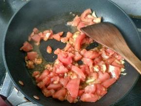 放入番茄，翻炒出汁。