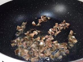 锅里放少许猪油，将腊肠放入翻炒