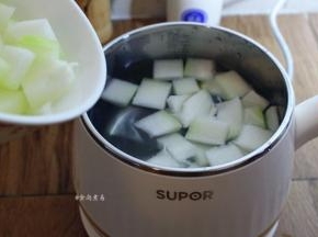 煮锅接通电源，锅内倒入清水，将冬瓜倒入锅中煮10分钟左右