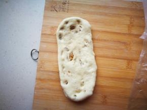 将面卷纵向放置，再次擀成长舌状。