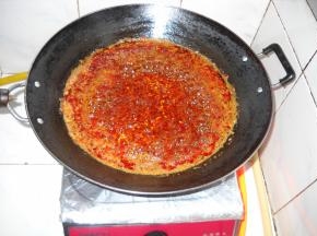 转小火慢慢熬制，锅中食油变成红色。