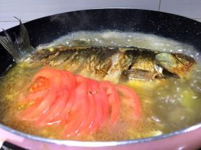 将切好的西红柿放入锅中