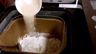 将豆浆、鸡蛋、盐、白砂糖、面粉依次放入面包机内，在面粉上挖出一小洞，放入酵母粉