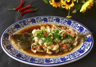 淋入调好的味汁，然后另起锅，加一大勺油烧至冒烟状，把热油浇在整条鱼身上，即可享受美味。