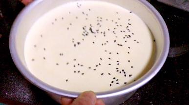 再倒入剩下的蛋糕糊，撒上黑芝麻，轻震几下，排气