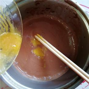 14.然后将蛋黄液倒入混合好的巧克力浆中，搅拌均匀；