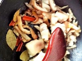 倒入猪蹄和猪皮翻炒，倒入姜蒜翻炒，再倒入香料翻炒出香味，倒入料酒和生抽翻炒