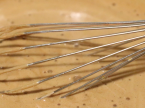 将沸腾的巧克力牛奶沿着装蛋黄容器的边缘慢慢倒入，边倒边电动转圈搅打匀。（沸腾的巧克力液倒入蛋黄中起到一个杀菌的做用，）