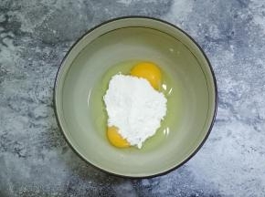 常温鸡蛋打入碗中，，加入糖粉，用手动打蛋器搅打均匀