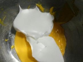 将打好的蛋白取1/3放入南瓜泥中，用翻拌的手法混合均匀，注意不能划圈搅拌，会消泡