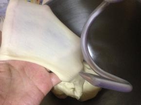 启动厨师机揉面，至面团能拉出薄膜的扩展阶段