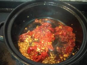 加入泡椒、郫县豆瓣酱，翻炒至油色红亮。