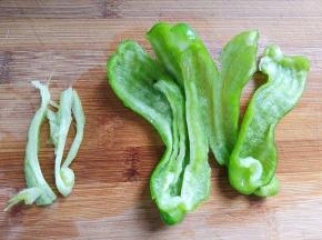 青椒去蒂去籽，把里面的白色的筋去掉，减轻辣味
