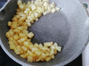 土豆丁煎至微黄后拨向一边；