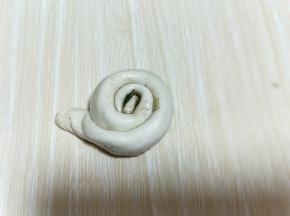 再将长条状卷起来，从一端卷到另一端。如图