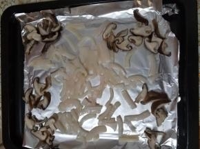 发酵面团的时候，我们把香菇烫好洗净切片，鱿鱼去皮切条，然后放到烤箱内烘烤下去掉水分，否则披萨的面饼水分太多影响口感。