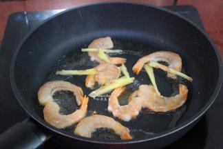 锅中再倒入点油，放入虾仁、生姜是煎熟；