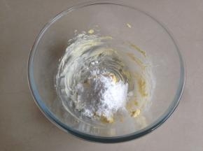 在等待面团发酵的过程中，制作椰蓉馅。黄油切小块软化后打软，加入糖粉