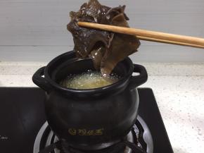 将木耳洗净后切块放入煲中