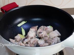 炒锅中放入适量的植物油，爆香葱姜后，放入焯水后的羊排翻炒