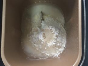 高、低筋面粉，酵母，清水，鸡蛋液到倒入搅拌桶，揉成光滑面团时放入28g室温软化黄油揉成能拉伸出膜即可