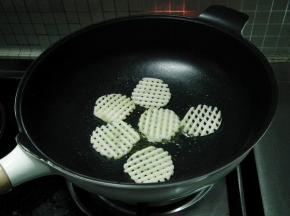 另起锅，烧热 下入一半的调味油，将薯格放入锅中。