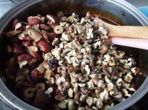 此时依然小火，暂时不要关火，先把核桃仁和枣片放入充分拌均匀，