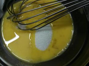 我们把鸡蛋用手动打蛋器勾散 加入细砂糖