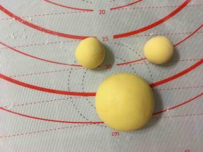 现在用黄色面团来制作一个小熊维尼哦，将黄色面团分成一个40克，2个10克，分别揉圆制作小熊维尼的头部，耳朵。