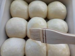 用手指粘点面粉轻轻按一下发好的面团，如果慢慢回弹证明已经发好了，刷一层蛋液，烤箱180度预热。