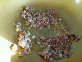 腌制好的肉沫倒入油中翻炒。