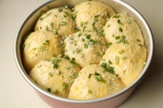 表面撒芝麻和香葱，刷上蛋液。