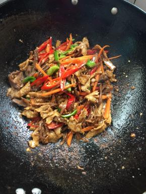 放入切好的萝卜干，红尖椒，青椒和胡萝卜条翻炒片刻。