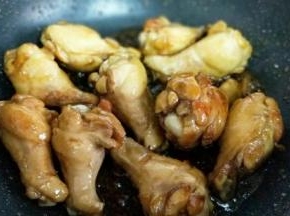 加入腌制好的鸡翅根，翻炒使糖色均匀挂满每个鸡翅根。