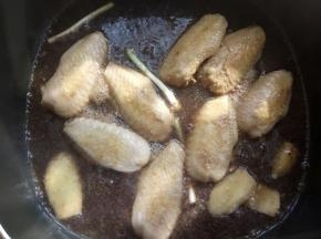 放入姜片，葱白，倒入可乐，没过鸡翅，加两勺老抽，大火煮10分钟左右，改小火收汁！