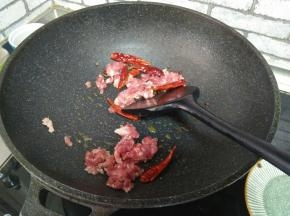 加入干红椒，麻椒。再加入肉末炒至变白。
