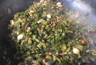 放入雪菜末和泡发好的黄豆、花生米，翻炒均匀，放入100ml的水，将肉末雪菜烧熟。